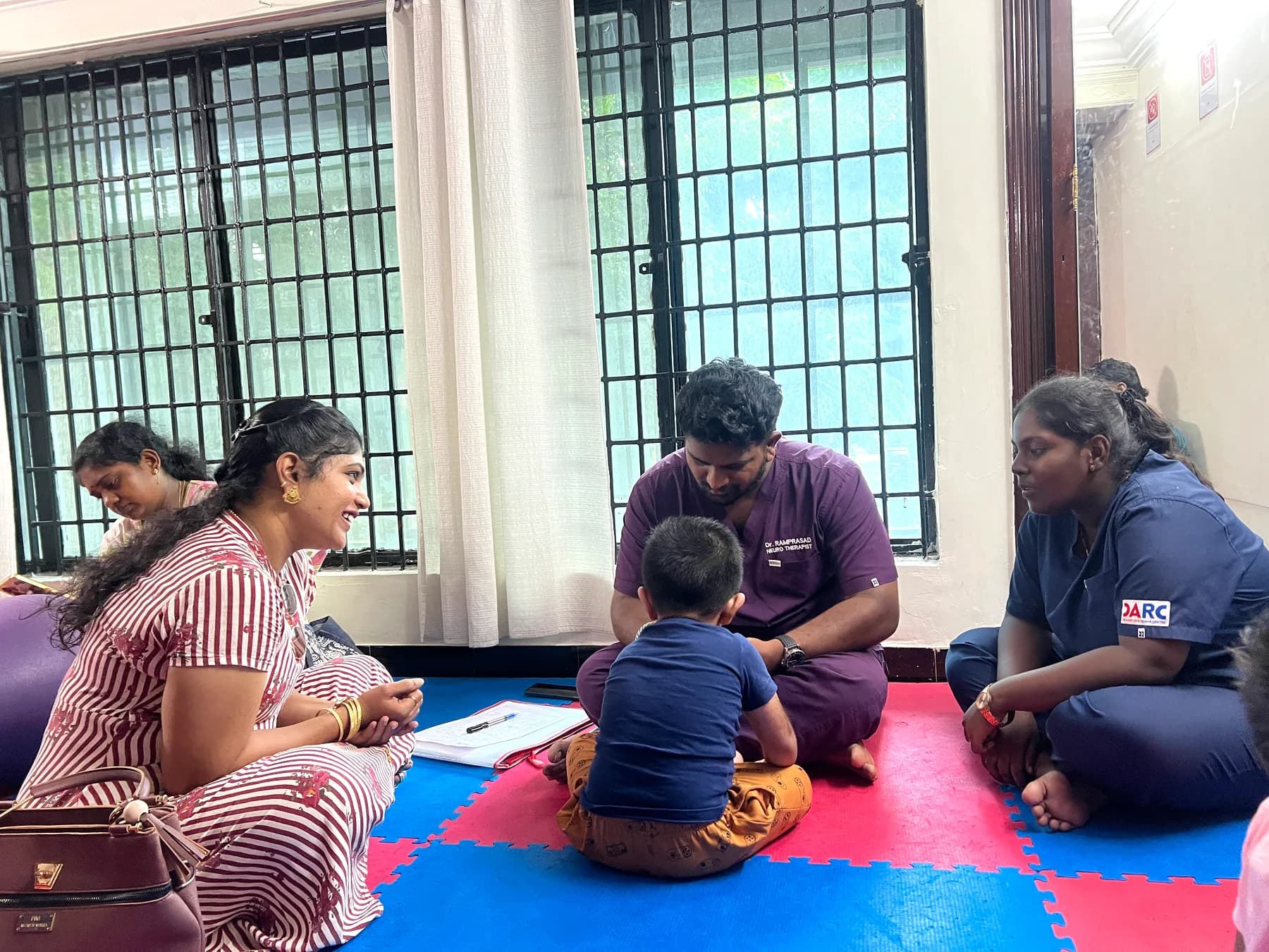 DARC team guiding a family in a therapy room