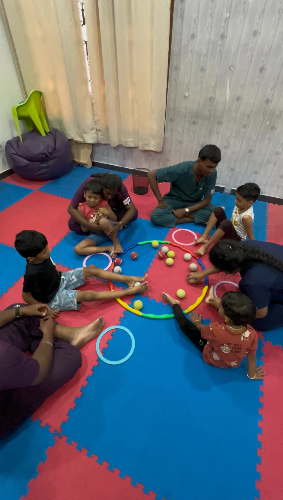 Children participating in group therapy floor activity at DARC Chennai